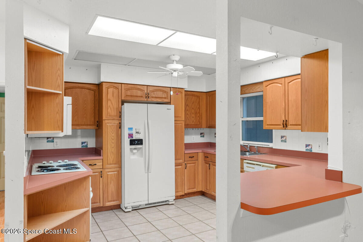 2493 Adamson Road Cocoa, FL 32926 - Photo 39 of 46 a kitchen with stainless steel appliances granite countertop a refrigerator and a stove