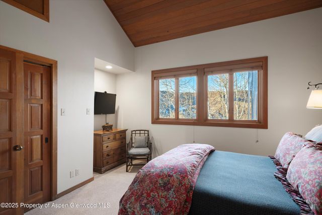 a bedroom with a bed and a television