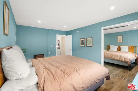 a bedroom with a bed and a couch