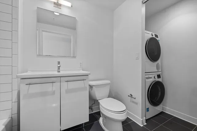 a bathroom with a toilet sink and vanity
