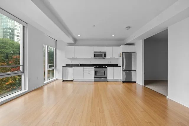 a view of kitchen with wooden floor and electronic appliances