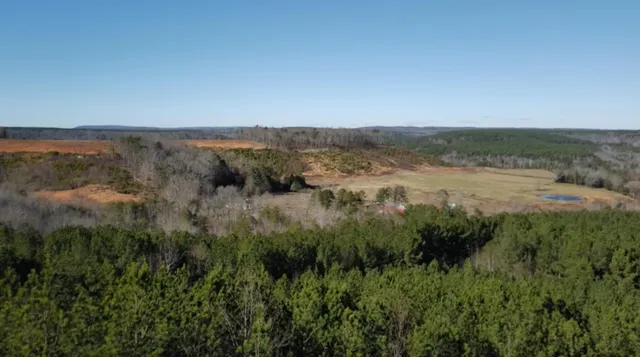 a view of a lake with houses in back