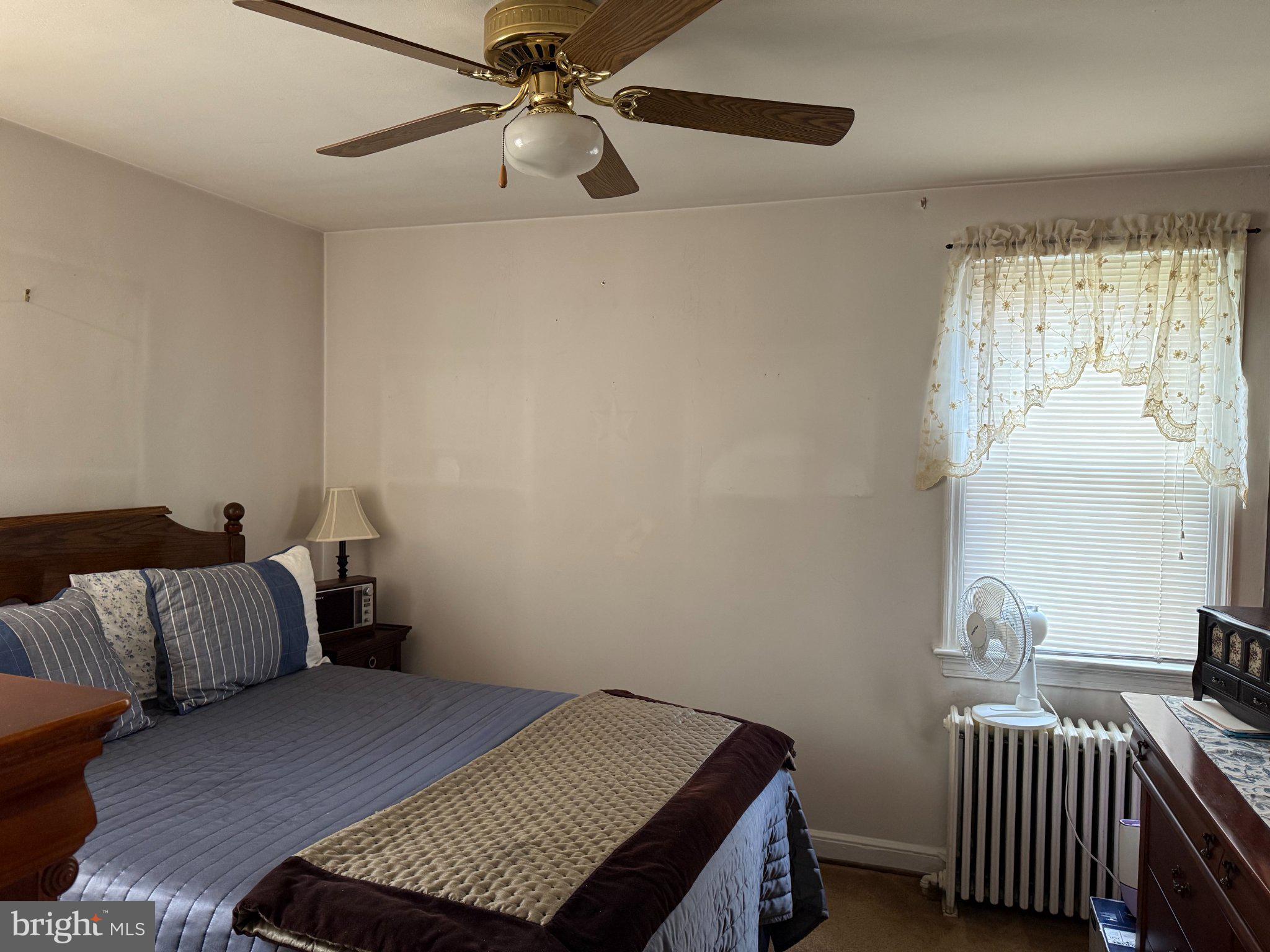 6117 Auth Road Suitland, MD 20746 - Photo 4 of 7 a bedroom with a bed and window