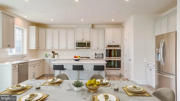 a kitchen with stainless steel appliances granite countertop a sink and dishwasher a refrigerator with wooden floor