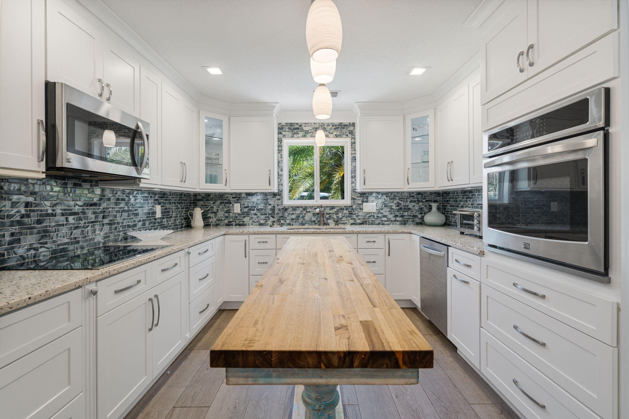 401 Surf Road Melbourne Beach, FL 32951 - Photo 19 of 94 a kitchen with white cabinets sink and window