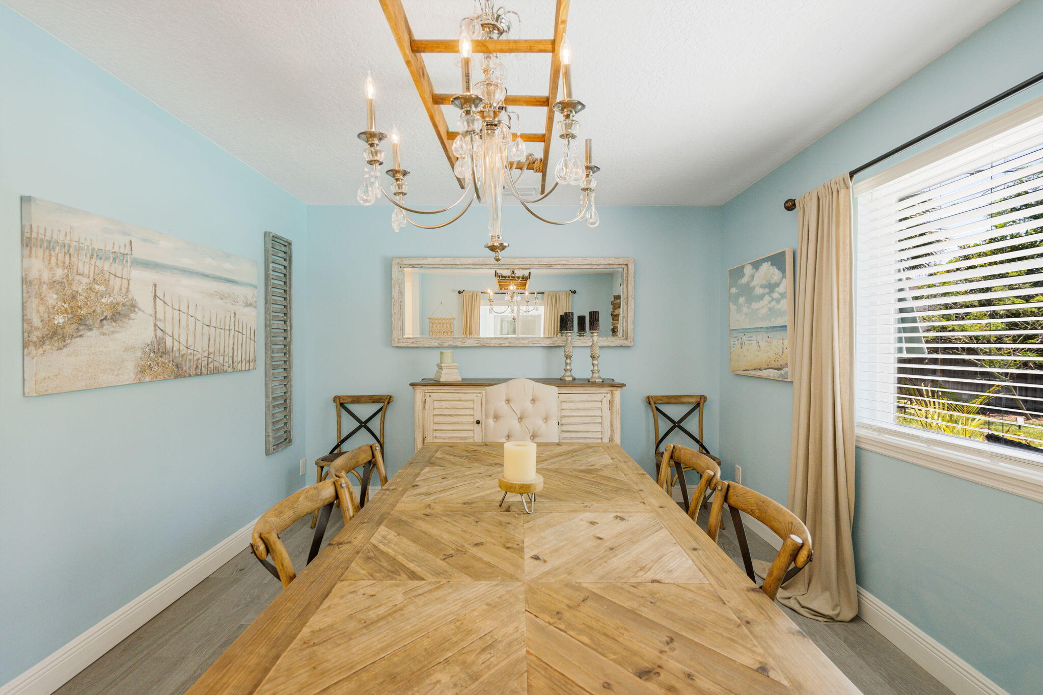 401 Surf Road Melbourne Beach, FL 32951 - Photo 31 of 94 a dining room with wooden floor and a chandelier