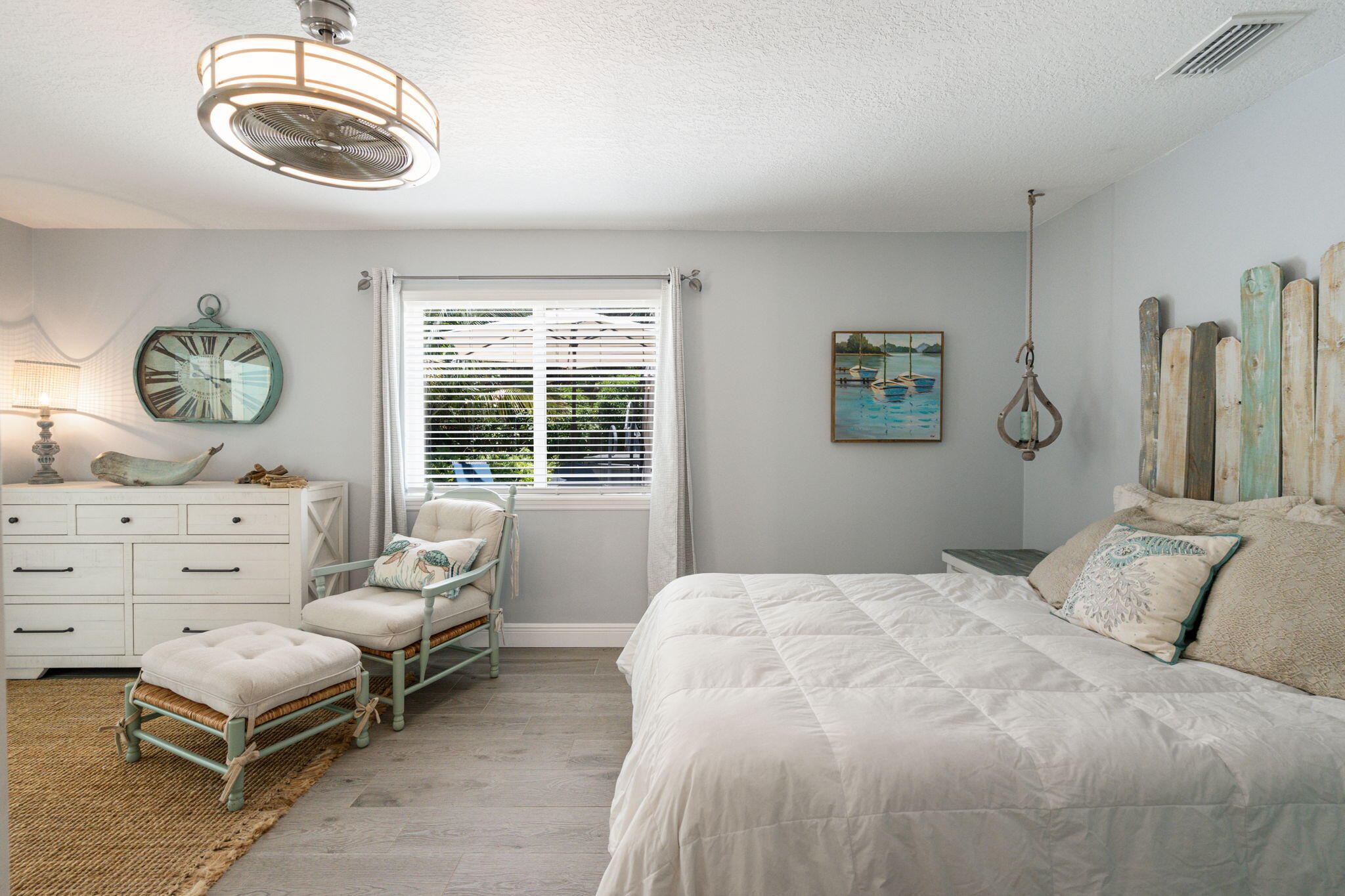 401 Surf Road Melbourne Beach, FL 32951 - Photo 37 of 94 a bedroom with a bed and a chandelier