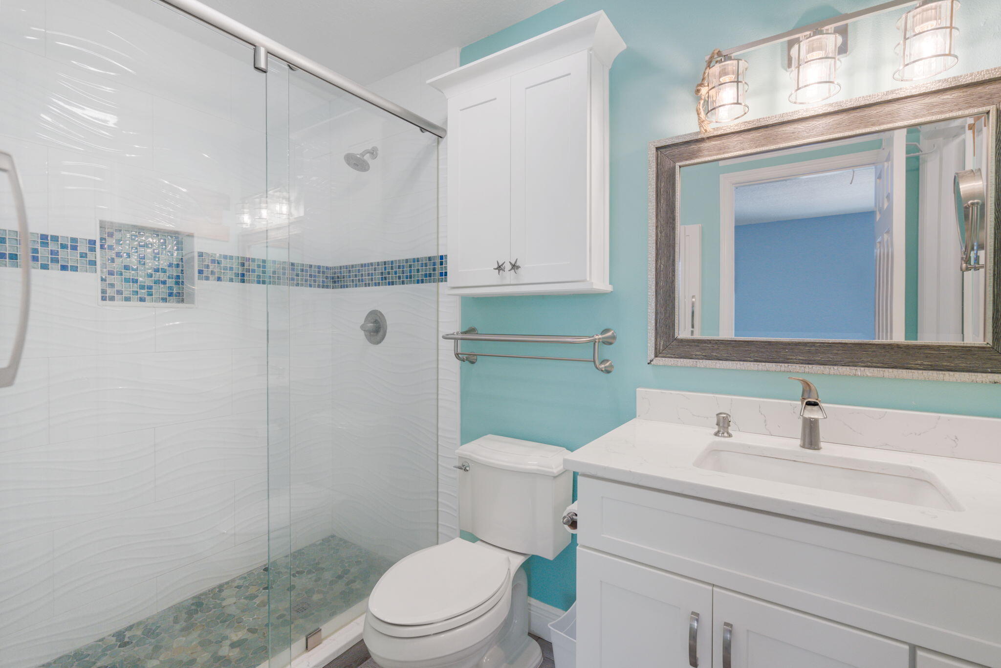 401 Surf Road Melbourne Beach, FL 32951 - Photo 39 of 94 a bathroom with a sink a toilet and a mirror