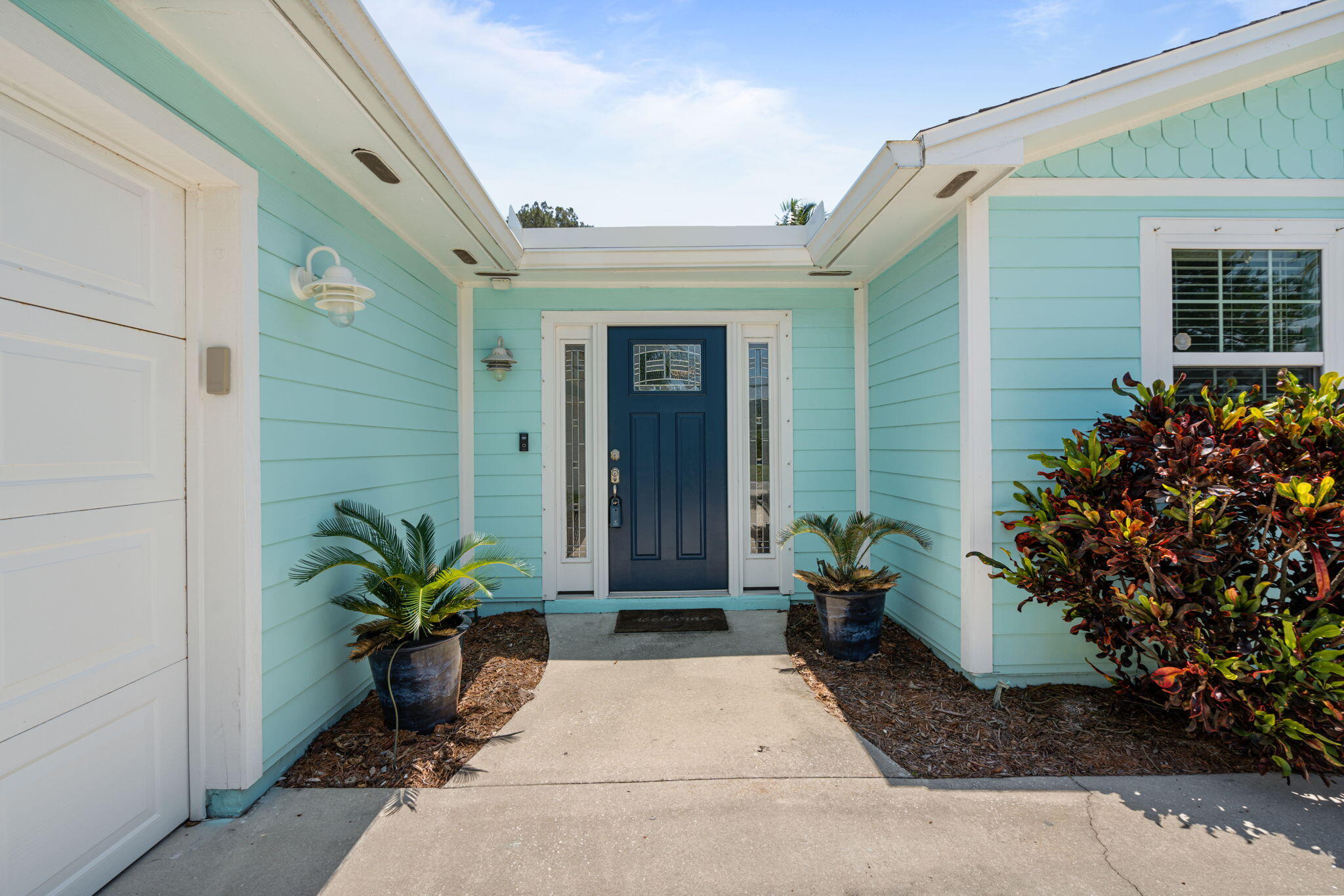 401 Surf Road Melbourne Beach, FL 32951 - Photo 4 of 94 a potted plant sitting in front of a house