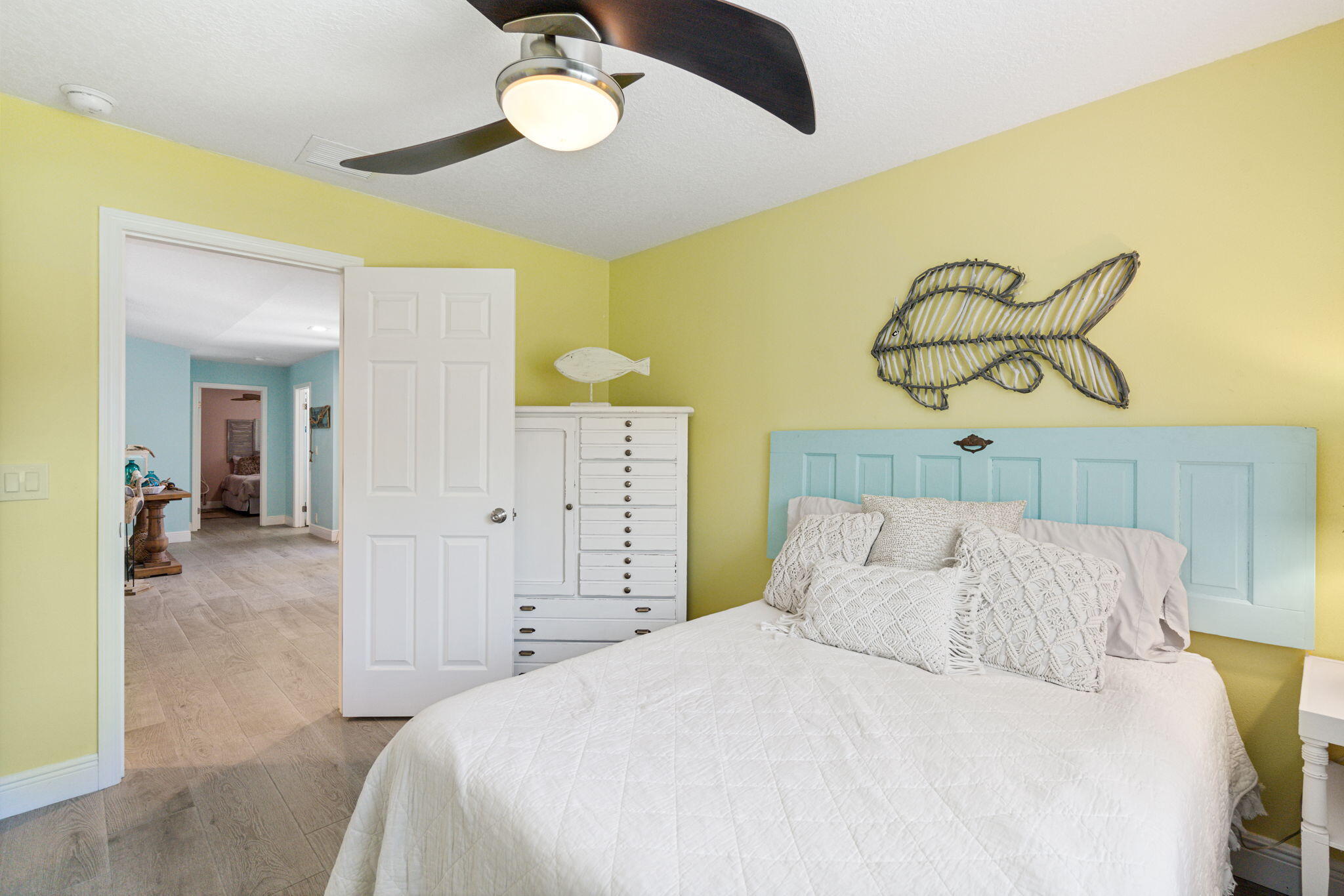 401 Surf Road Melbourne Beach, FL 32951 - Photo 45 of 94 a bedroom with a bed and a chandelier
