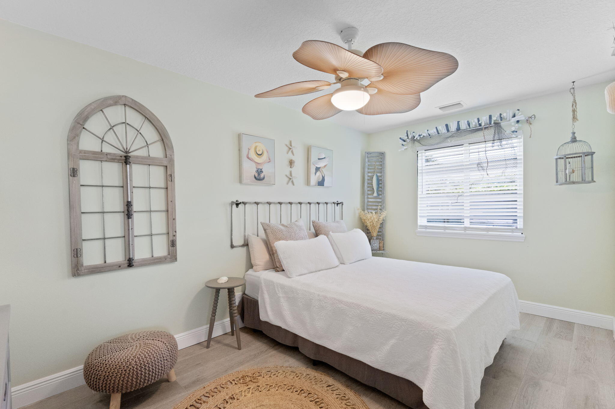 401 Surf Road Melbourne Beach, FL 32951 - Photo 46 of 94 a bedroom with a large bed and a chandelier