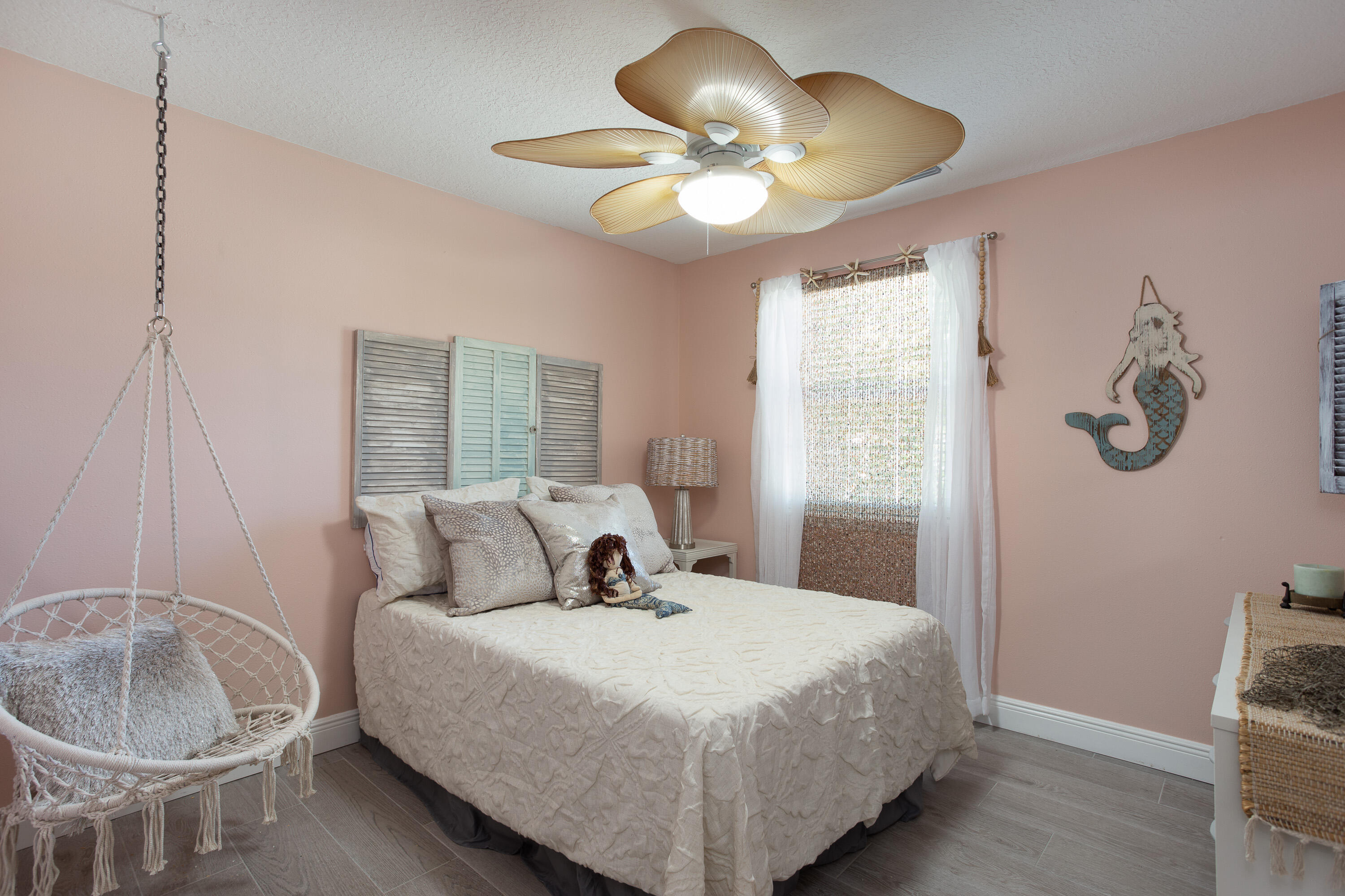 401 Surf Road Melbourne Beach, FL 32951 - Photo 49 of 94 a bedroom with a bed and a chandelier