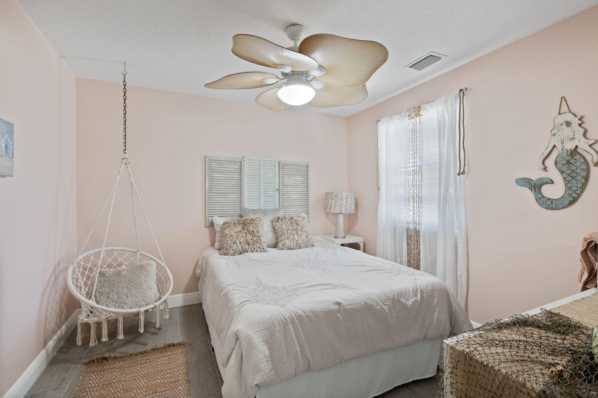 401 Surf Road Melbourne Beach, FL 32951 - Photo 50 of 94 a bedroom with a bed and a chandelier