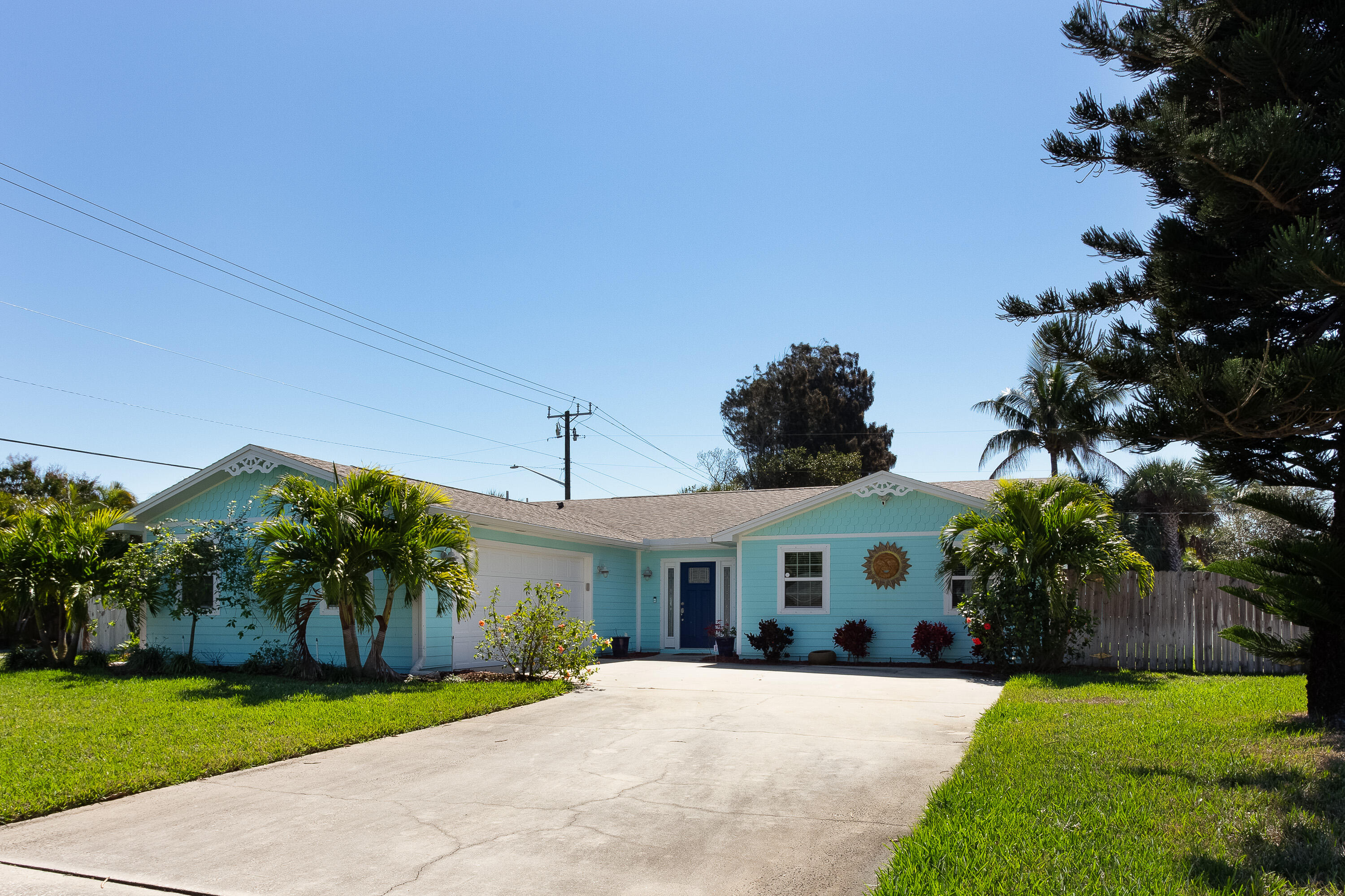 401 Surf Road Melbourne Beach, FL 32951 - Photo 5 of 94 a front view of a house with a yard and garage