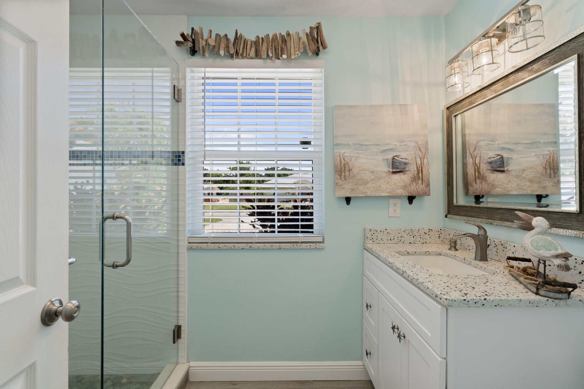 401 Surf Road Melbourne Beach, FL 32951 - Photo 52 of 94 a bathroom with a granite countertop sink a mirror and shower