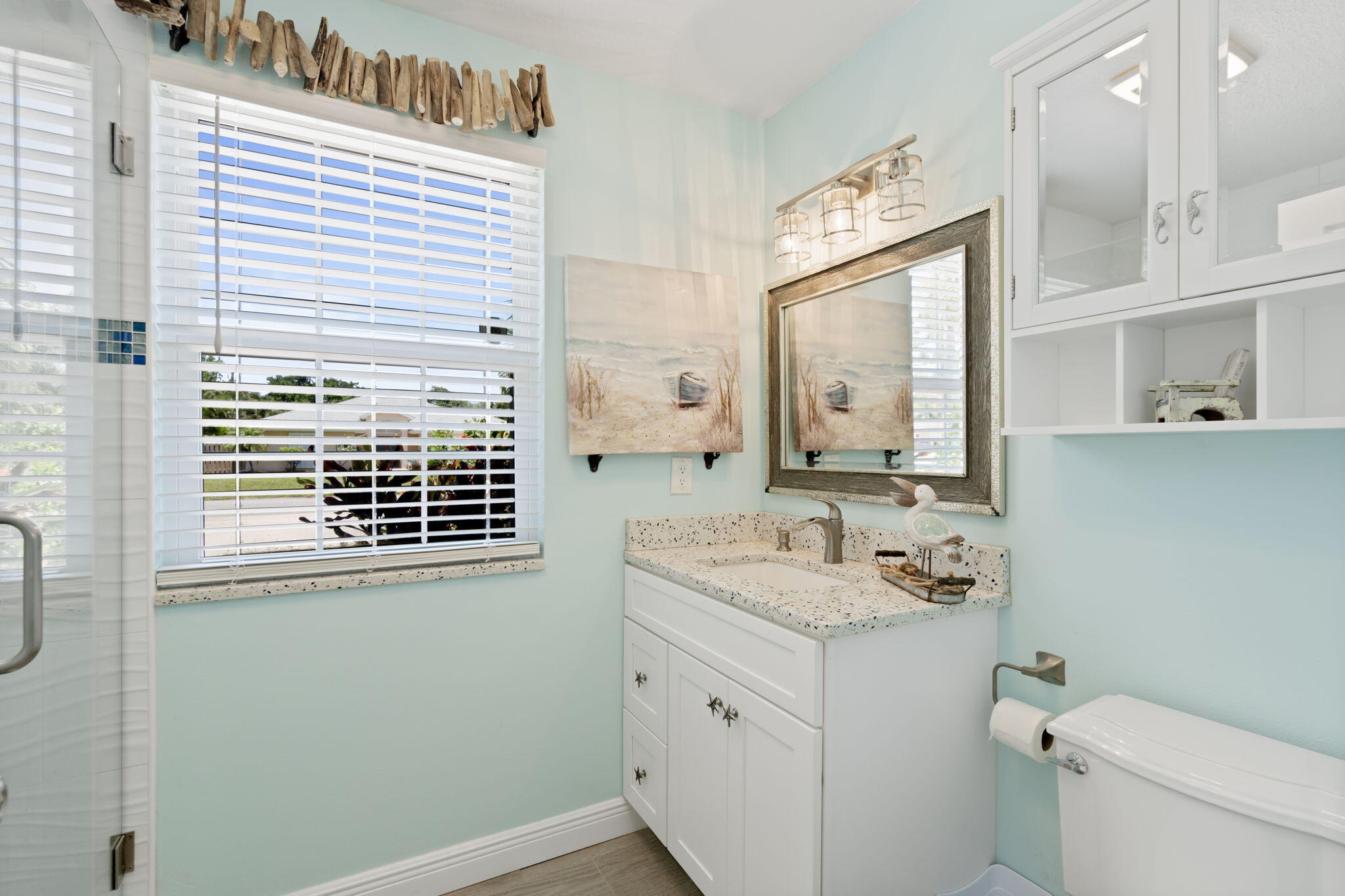 401 Surf Road Melbourne Beach, FL 32951 - Photo 53 of 94 a bathroom with a granite countertop sink toilet and mirror