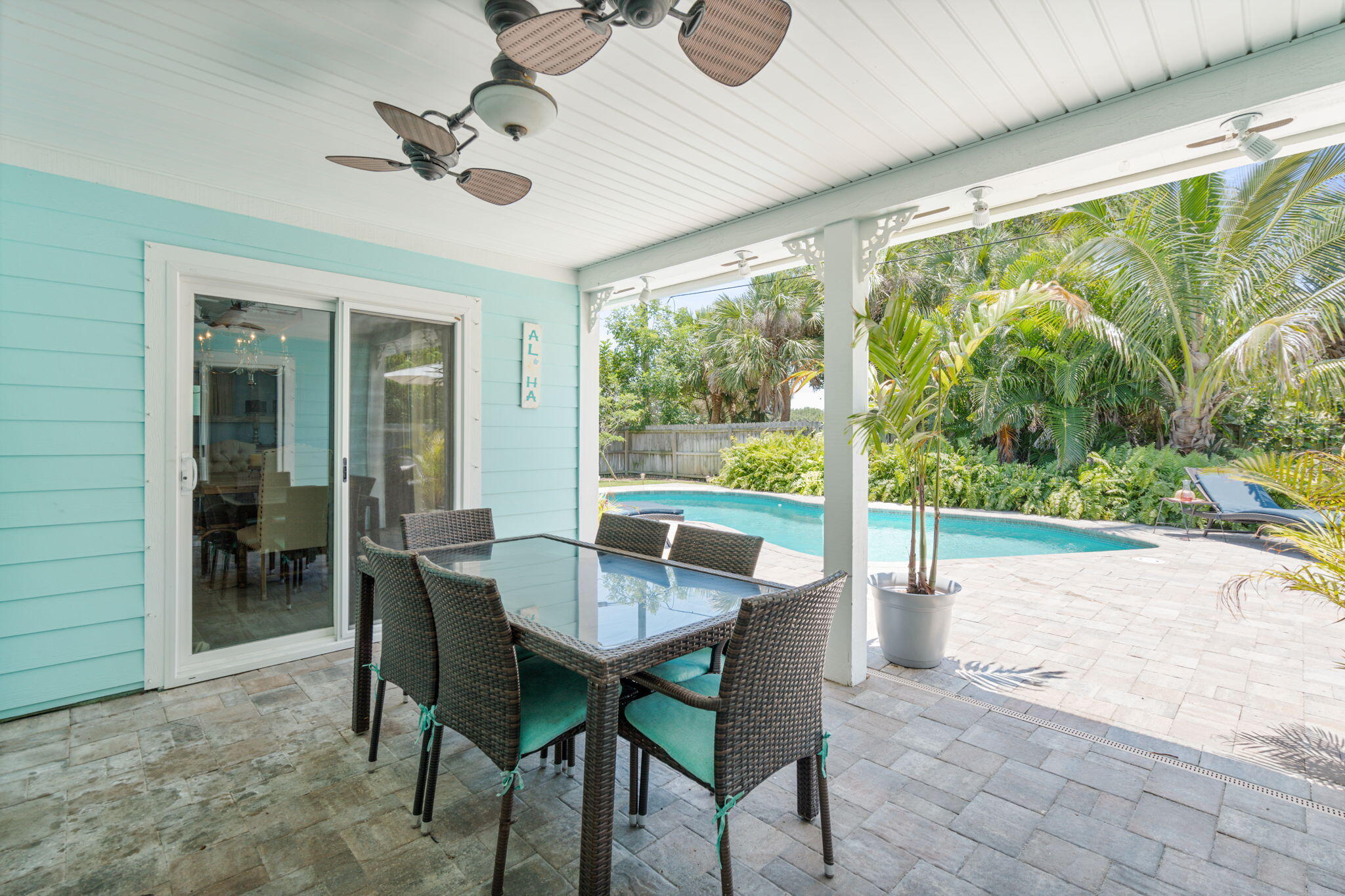 401 Surf Road Melbourne Beach, FL 32951 - Photo 74 of 94 a dining room with furniture and a floor to ceiling window