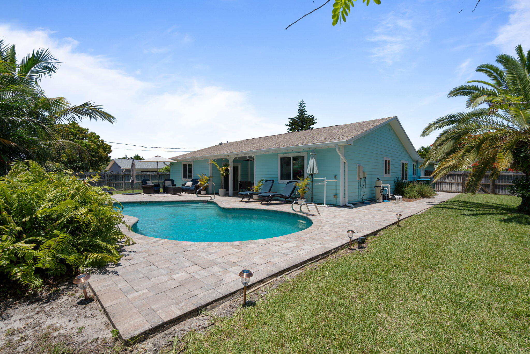 401 Surf Road Melbourne Beach, FL 32951 - Photo 75 of 94 a view of a house with a swimming pool and a yard