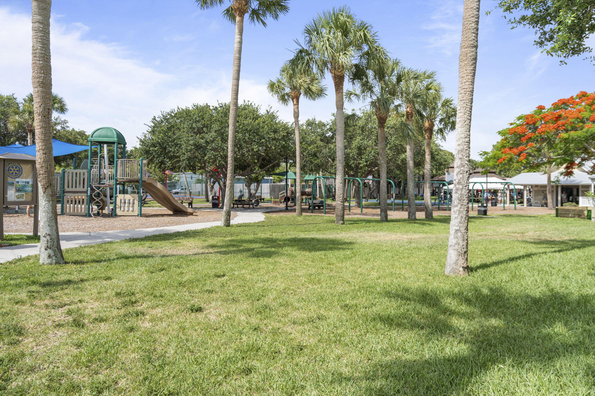 401 Surf Road Melbourne Beach, FL 32951 - Photo 91 of 94 a view of a park with swings and a palm tree