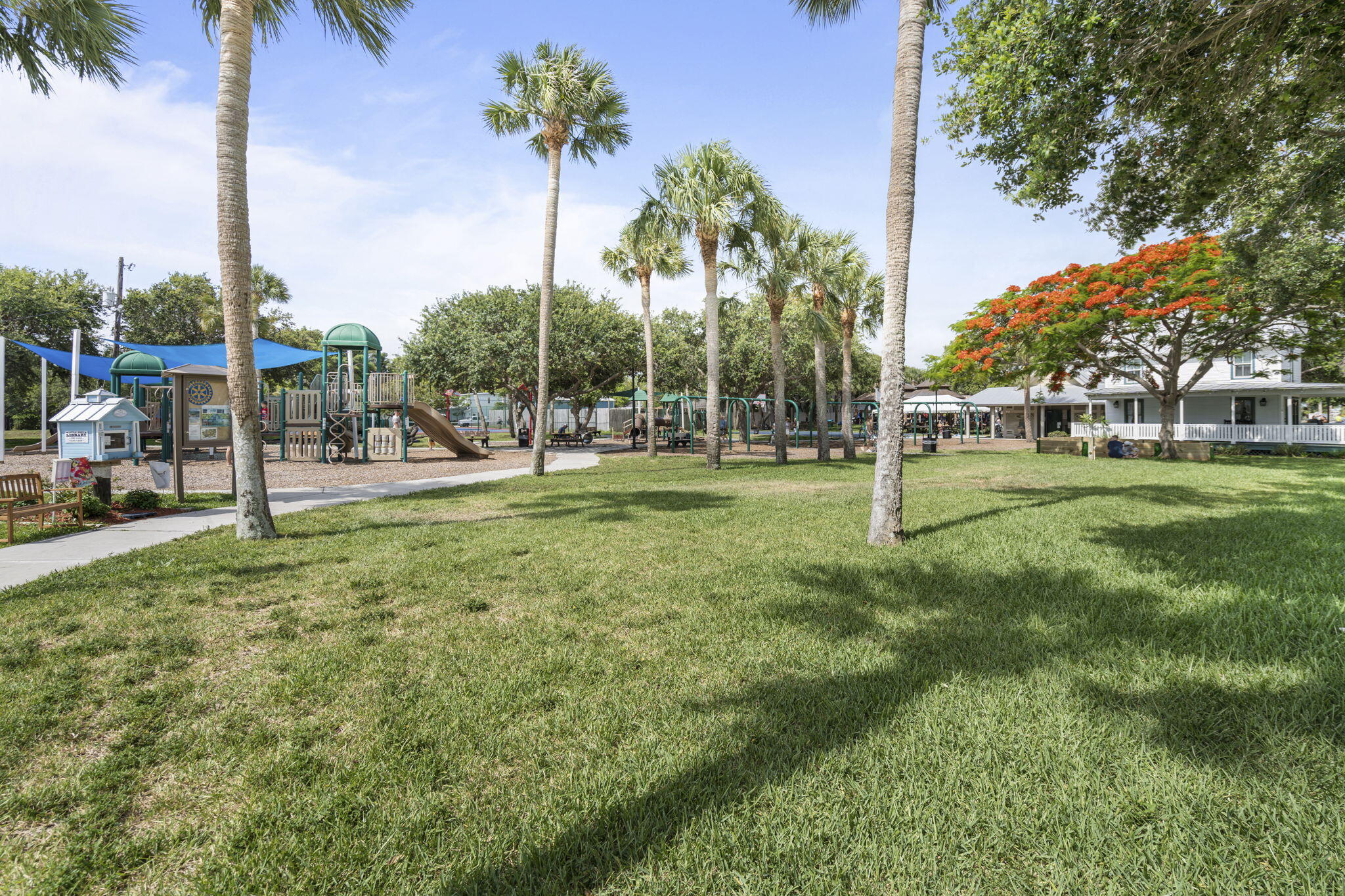 401 Surf Road Melbourne Beach, FL 32951 - Photo 92 of 94 a view of a park with swings and palm trees