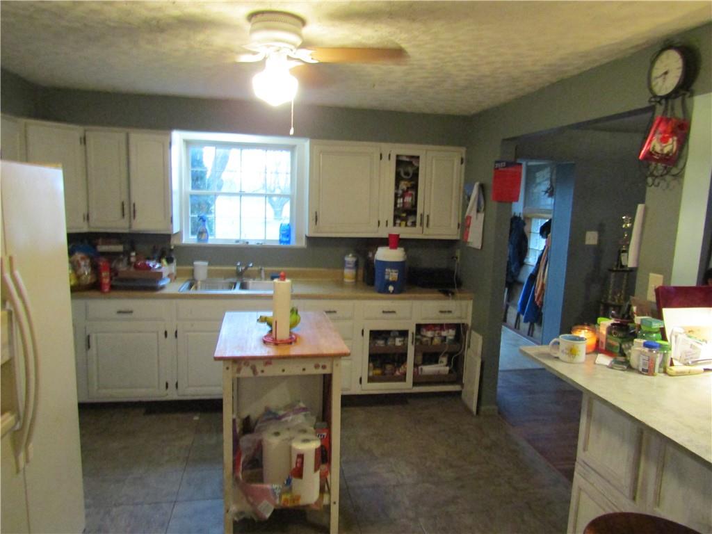 1177 Bend Road Mercer, PA 16137 - Photo 7 of 9 a kitchen with kitchen island granite countertop a stove a sink and a refrigerator