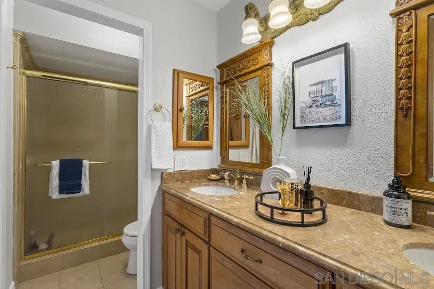 156 Little Oaks Road Encinitas, CA 92024 - Photo 15 of 38 a bathroom with a granite countertop sink toilet and shower