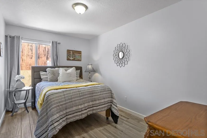 156 Little Oaks Road Encinitas, CA 92024 - Photo 16 of 38 a bedroom with a bed and a window