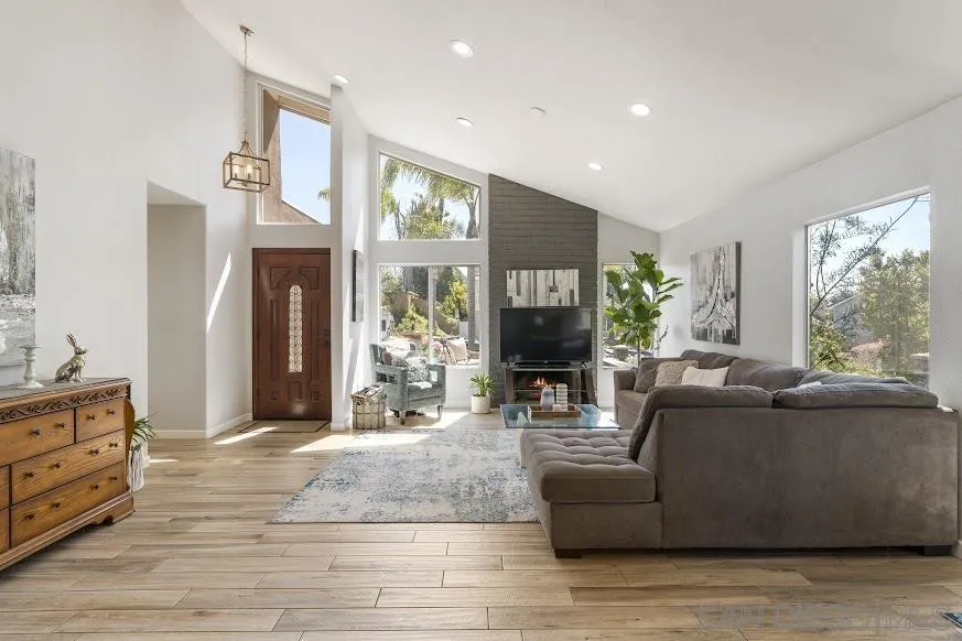 156 Little Oaks Road Encinitas, CA 92024 - Photo 2 of 38 a living room with furniture a large window and a fireplace
