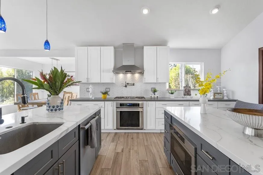 156 Little Oaks Road Encinitas, CA 92024 - Photo 5 of 38 a kitchen with stainless steel appliances granite countertop a sink stove and cabinets