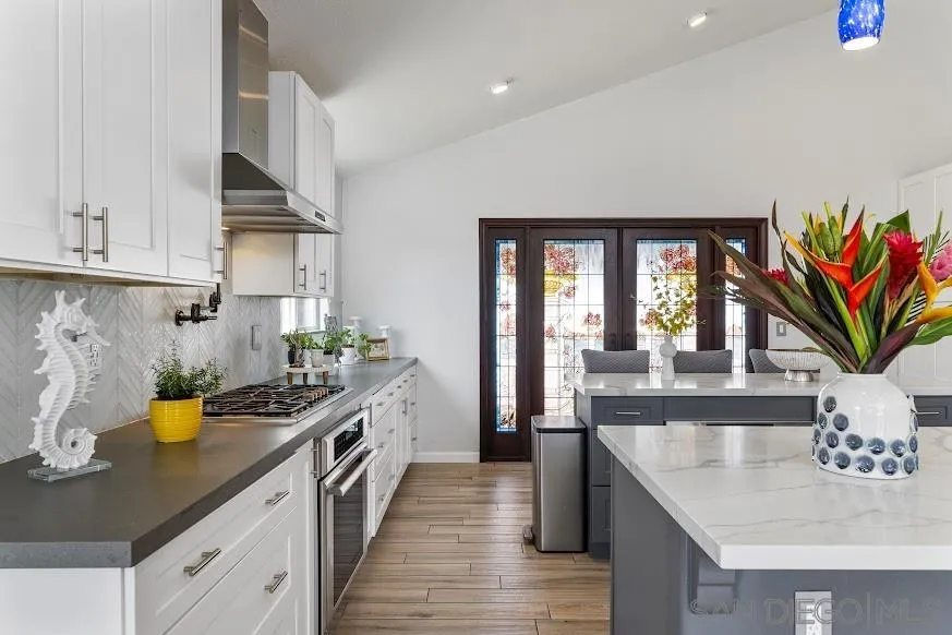 156 Little Oaks Road Encinitas, CA 92024 - Photo 6 of 38 a kitchen with stainless steel appliances granite countertop a sink a stove and a wooden floors