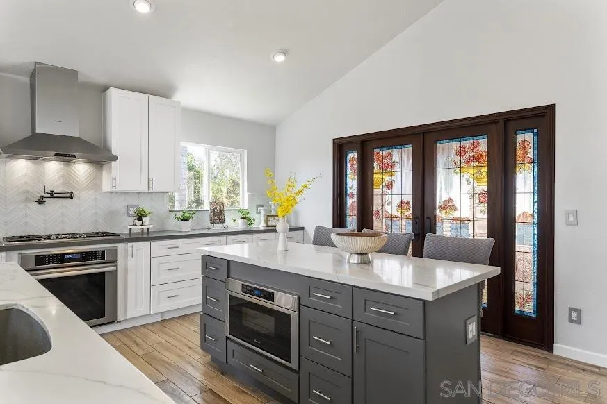 156 Little Oaks Road Encinitas, CA 92024 - Photo 8 of 38 a kitchen with a sink stove and cabinets