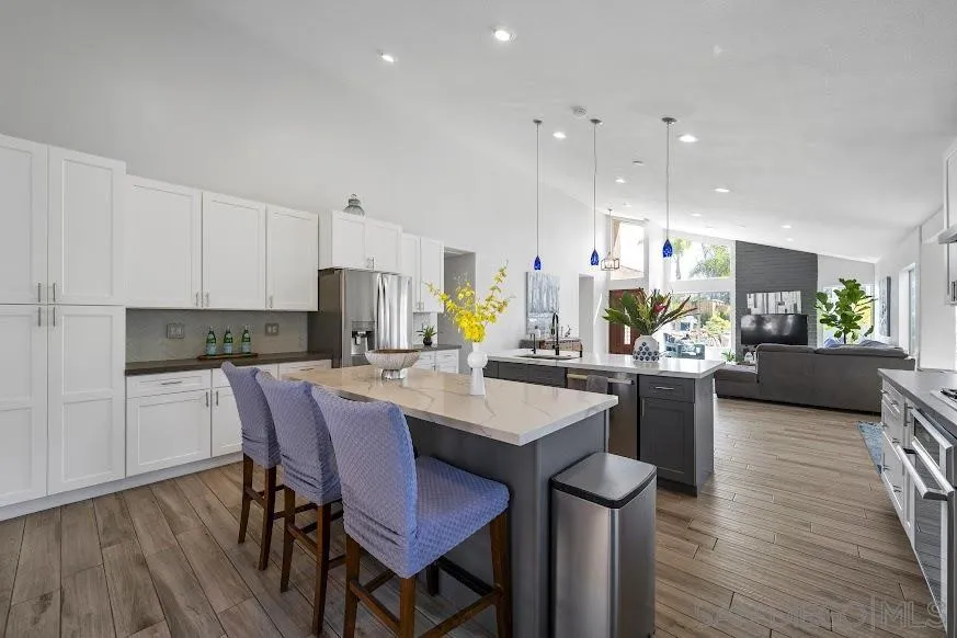 156 Little Oaks Road Encinitas, CA 92024 - Photo 9 of 38 a kitchen with a dining table chairs and wooden floor