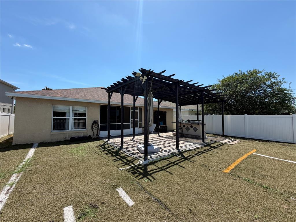 945 Tramells Trail Kissimmee, FL 34744 - Photo 30 of 36 a view of a house with backyard and sitting area
