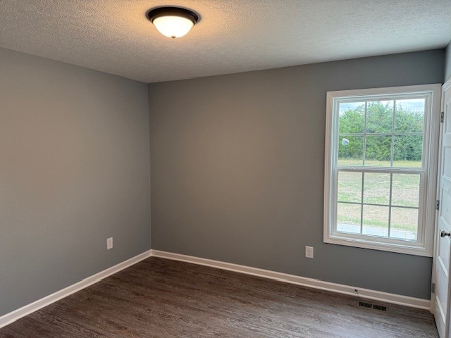 1415 Old Estill Springs Road Tullahoma, TN 37388 - Photo 12 of 25 an empty room with wooden floor and windows