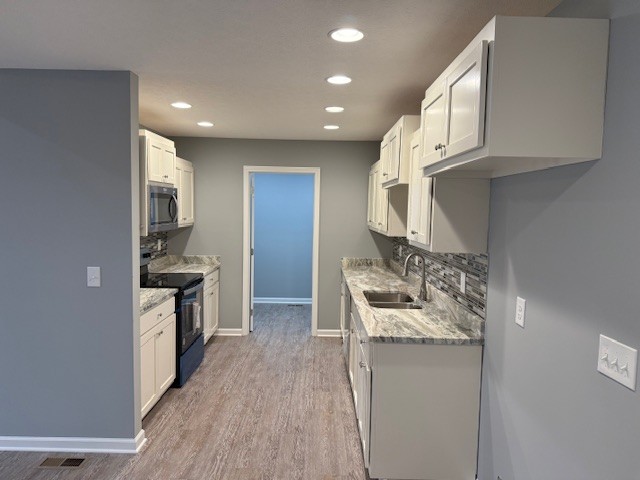 1415 Old Estill Springs Road Tullahoma, TN 37388 - Photo 10 of 25 a kitchen with stainless steel appliances granite countertop a sink stove and refrigerator