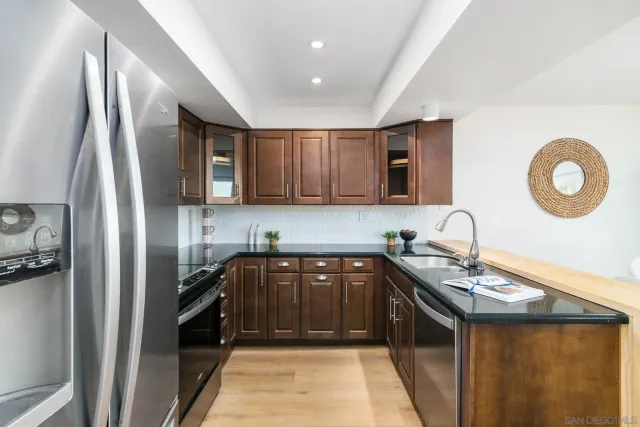 a kitchen with a sink appliances and cabinets