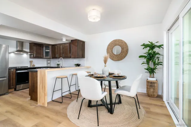 a view of kitchen with sink dining table and chairs