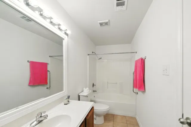 a bathroom with a sink vanity and a mirror