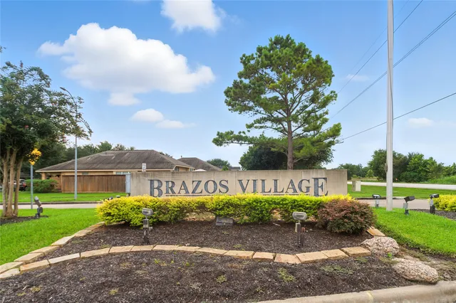 a front view of a house with a yard and a garage