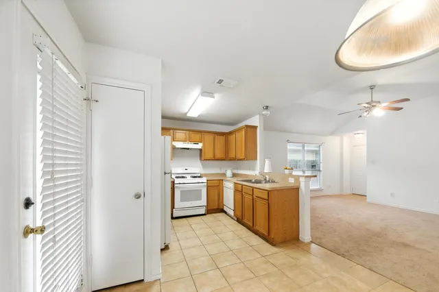 a kitchen with a stove a refrigerator and a sink