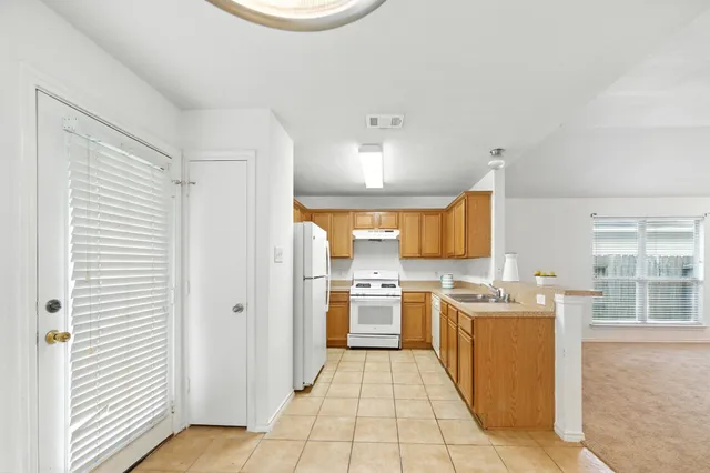 a kitchen with a stove a sink and a refrigerator