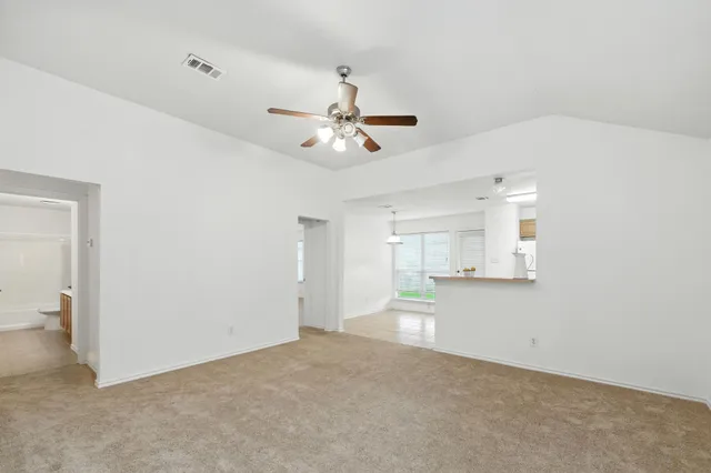 a view of a kitchen with a sink and a chandelier fan