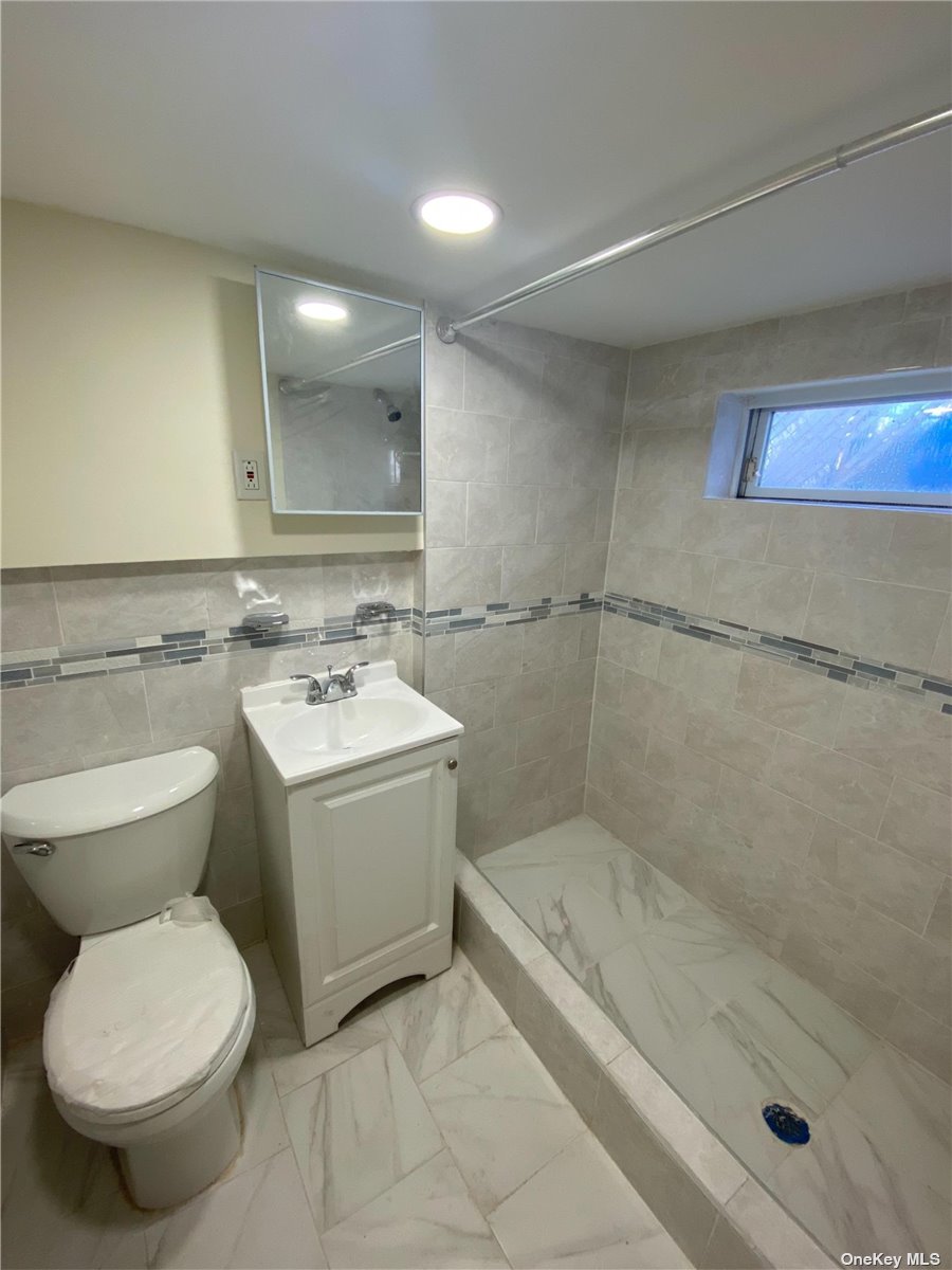 a bathroom with a sink mirror toilet and bathtub