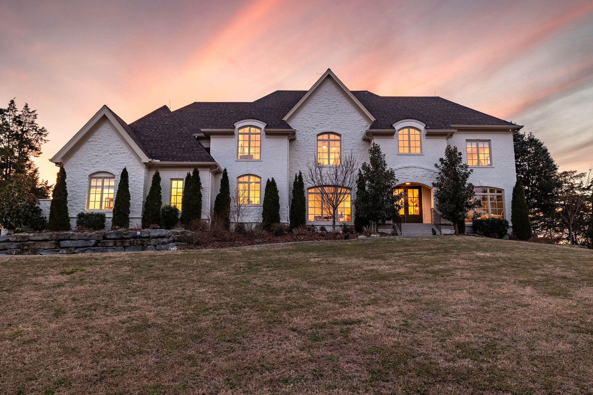 a front view of a house with garden