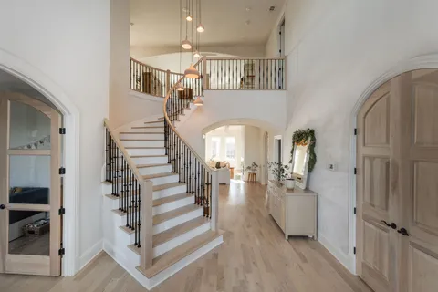 a view of entryway and hall with wooden floor