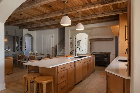 a large kitchen with a table and chairs