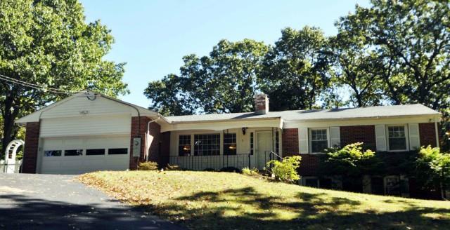 a view of a house with a yard in front of it