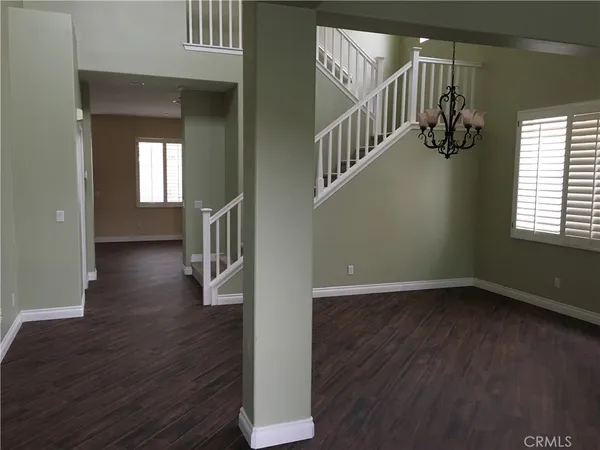 a view of an entryway with wooden floor