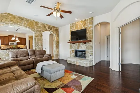 a living room with furniture fireplace and flat screen tv