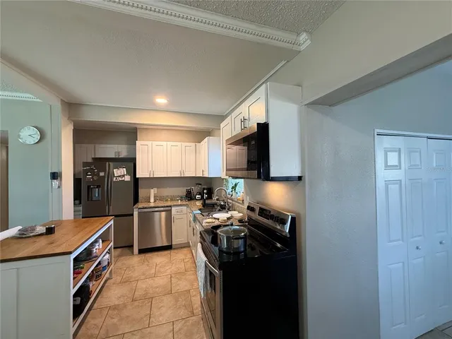 a kitchen with a stove and a refrigerator